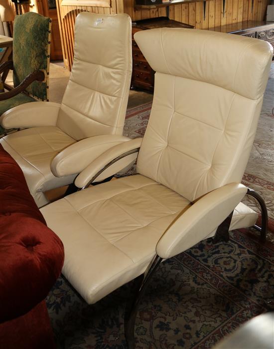 2 x cream leather reclining armchairs